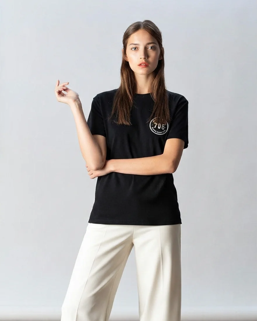 The tee worn by a model in a studio.